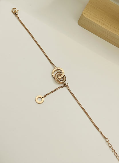 Rose Gold bracelet with a clasp on a light gray background