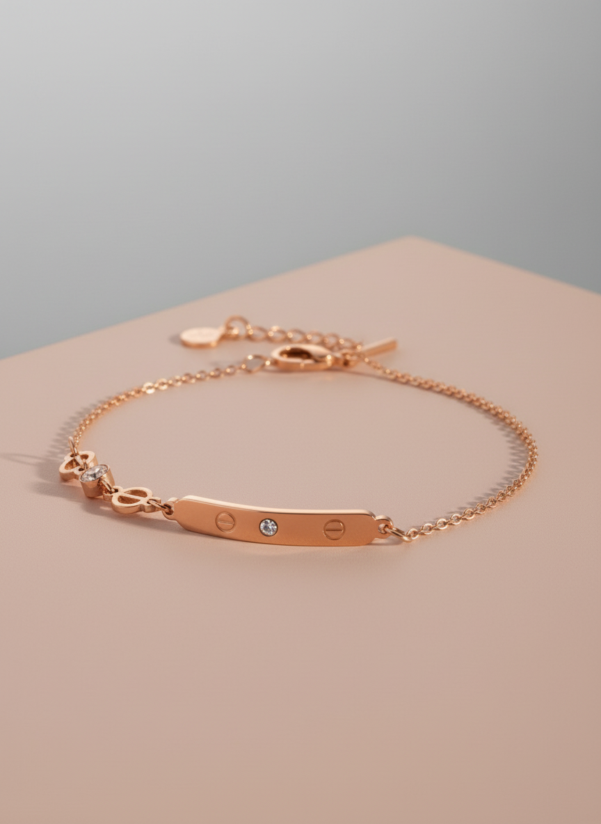 Rose gold bracelet on a beige surface with a gray background