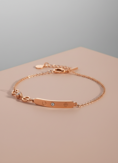 Rose gold bracelet on a beige surface with a gray background