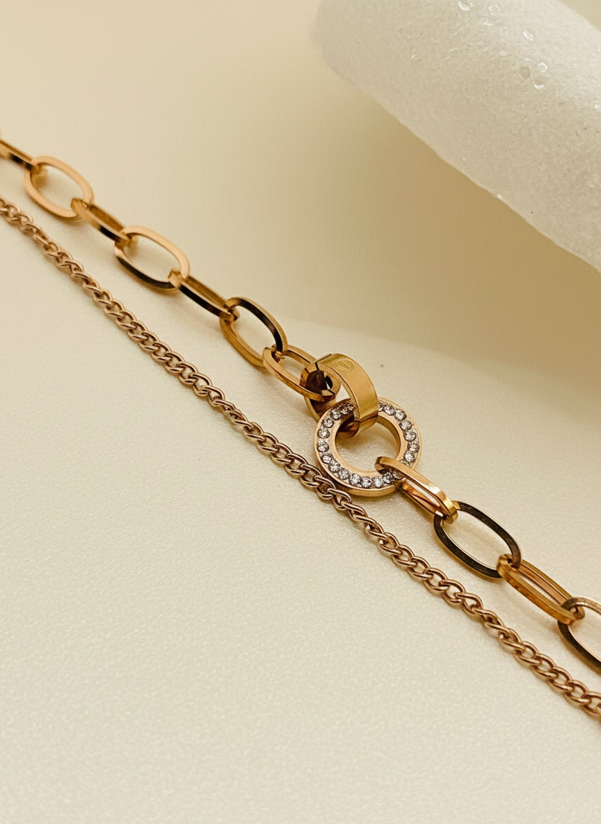 Rose Gold chain bracelet with a unique clasp on a beige background