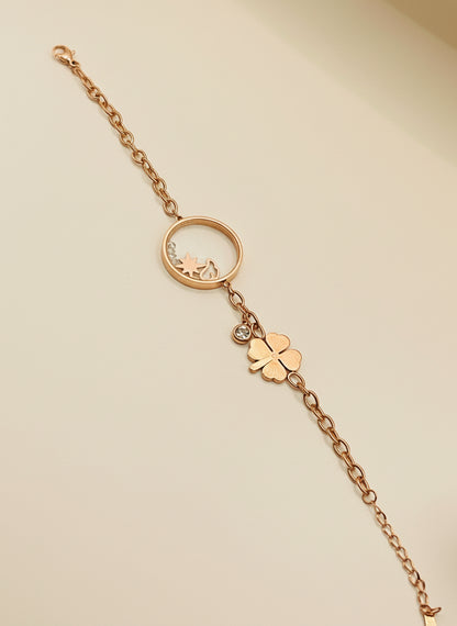 Rose Gold bracelet with clover charm on a white background