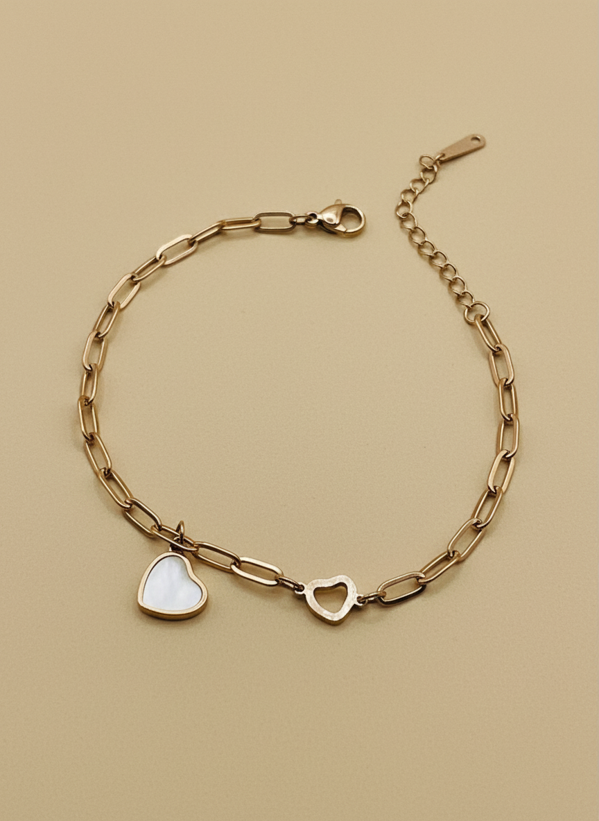 Rose Gold chain bracelet with heart-shaped charms on a beige background
