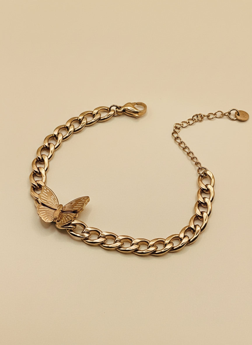 Rose Gold chain bracelet with a butterfly charm on a beige background