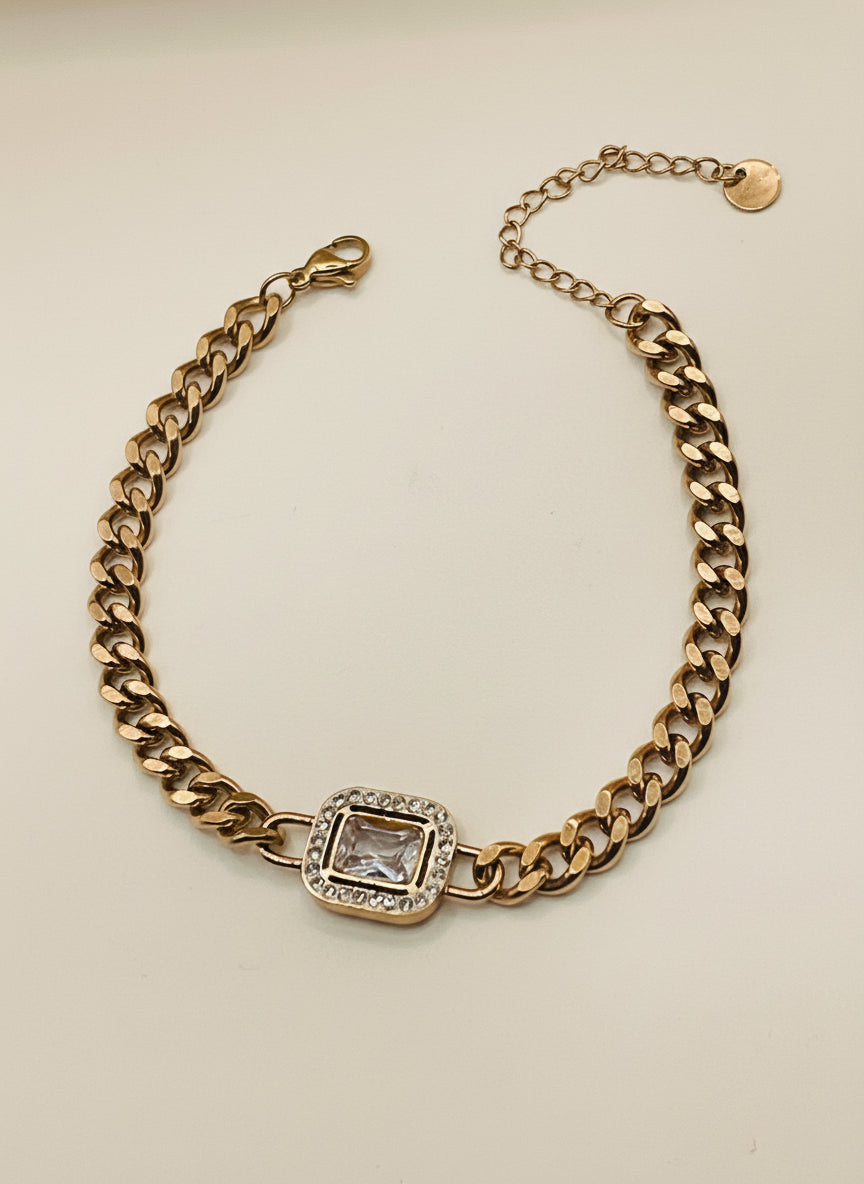 Rose Gold chain bracelet with a square gemstone on a light gray background