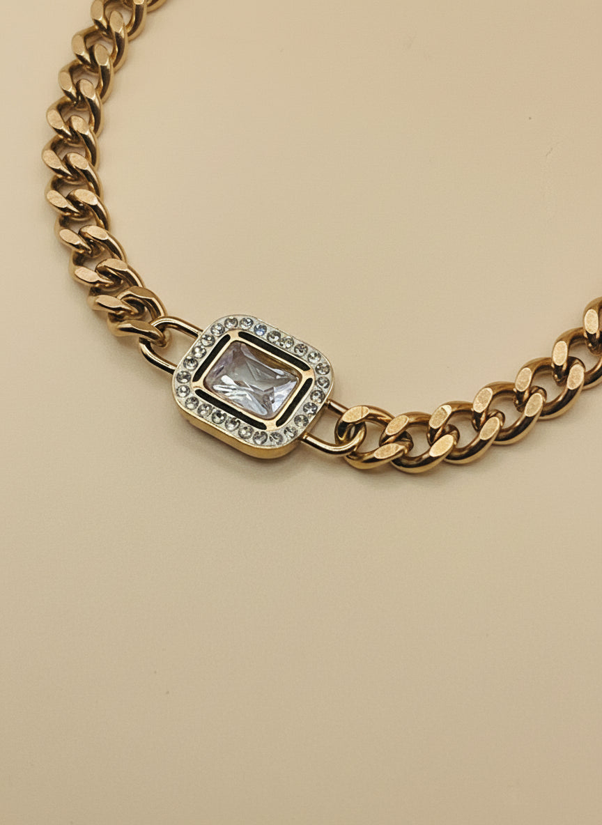 Rose Gold chain necklace with a diamond pendant on a light gray background