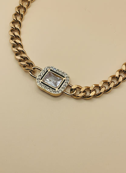 Rose Gold chain necklace with a diamond pendant on a light gray background