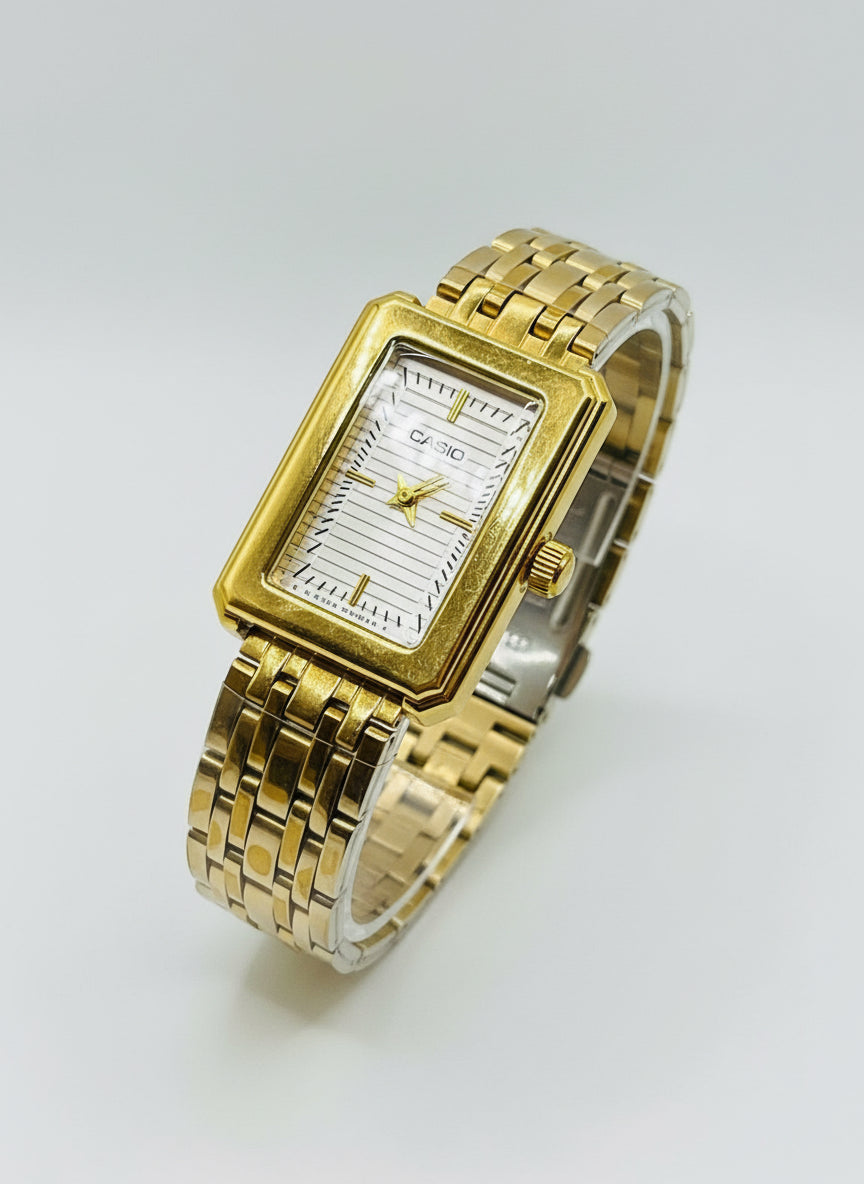Gold wristwatch on a white cushion
