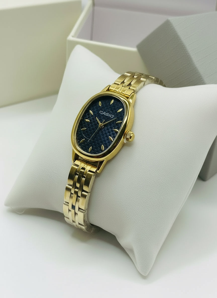 Gold Casio watch on a white cushion