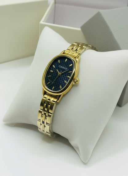 Gold Casio watch on a white cushion