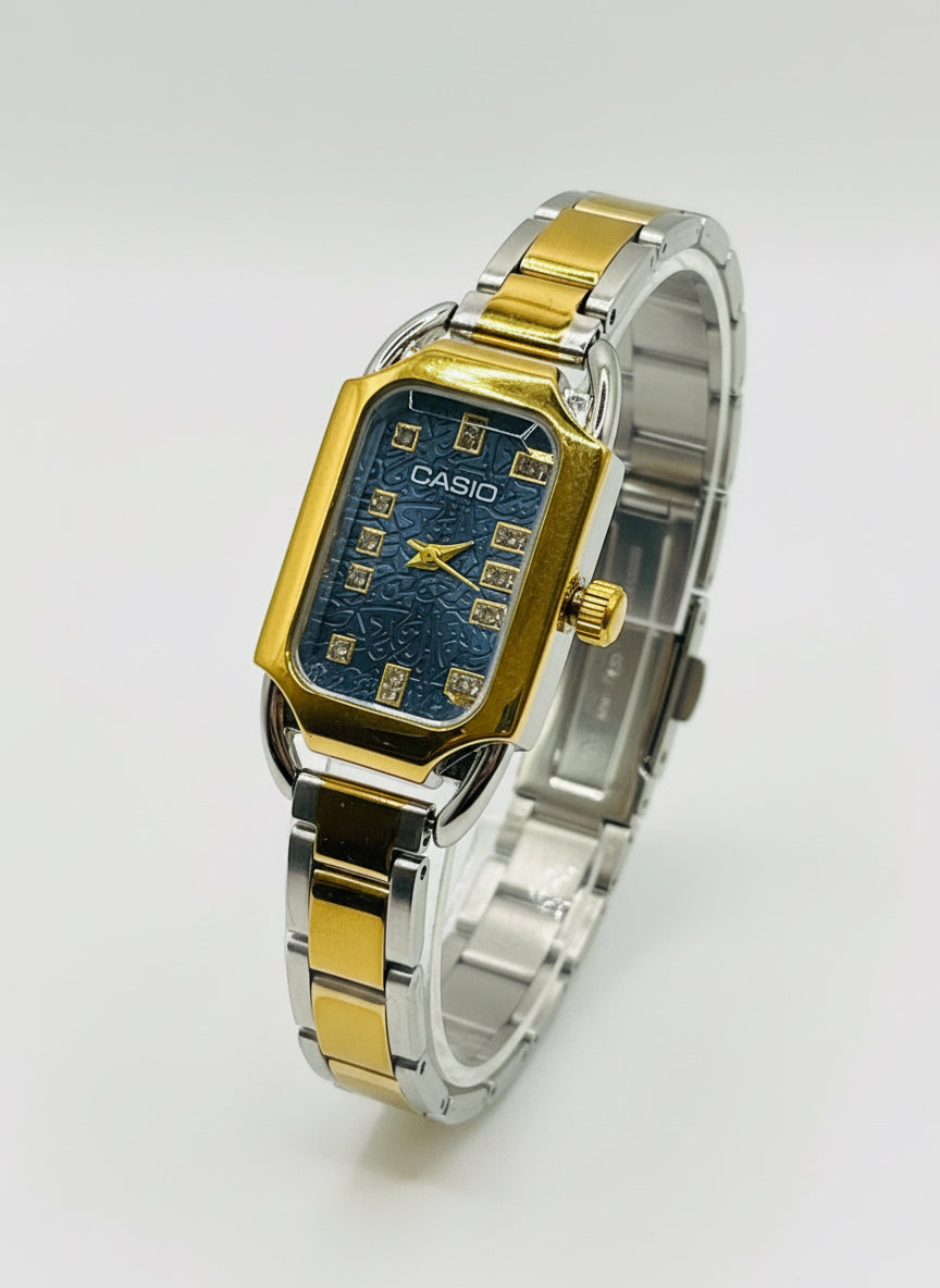 Casio watch with gold and silver band on a white cushion