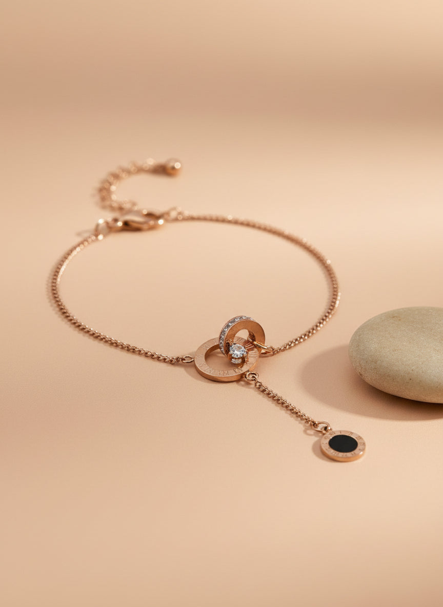 Rose Gold necklace with black pendant on a textured white surface