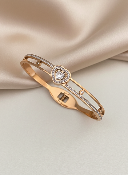 Rose gold bracelet with heart design on a beige fabric background