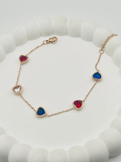 Bracelet with heart-shaped gemstones on a white cushion