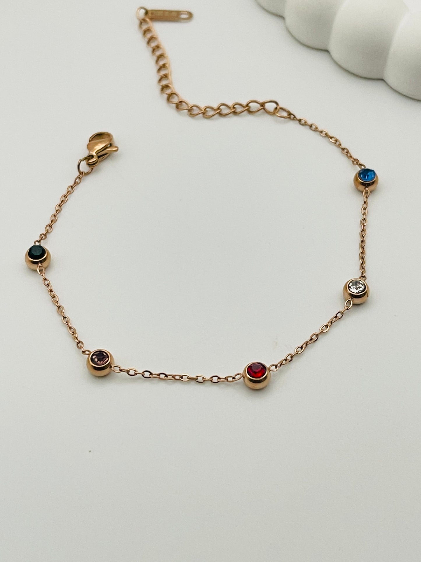 Rose Gold bracelet with gemstones on a white background