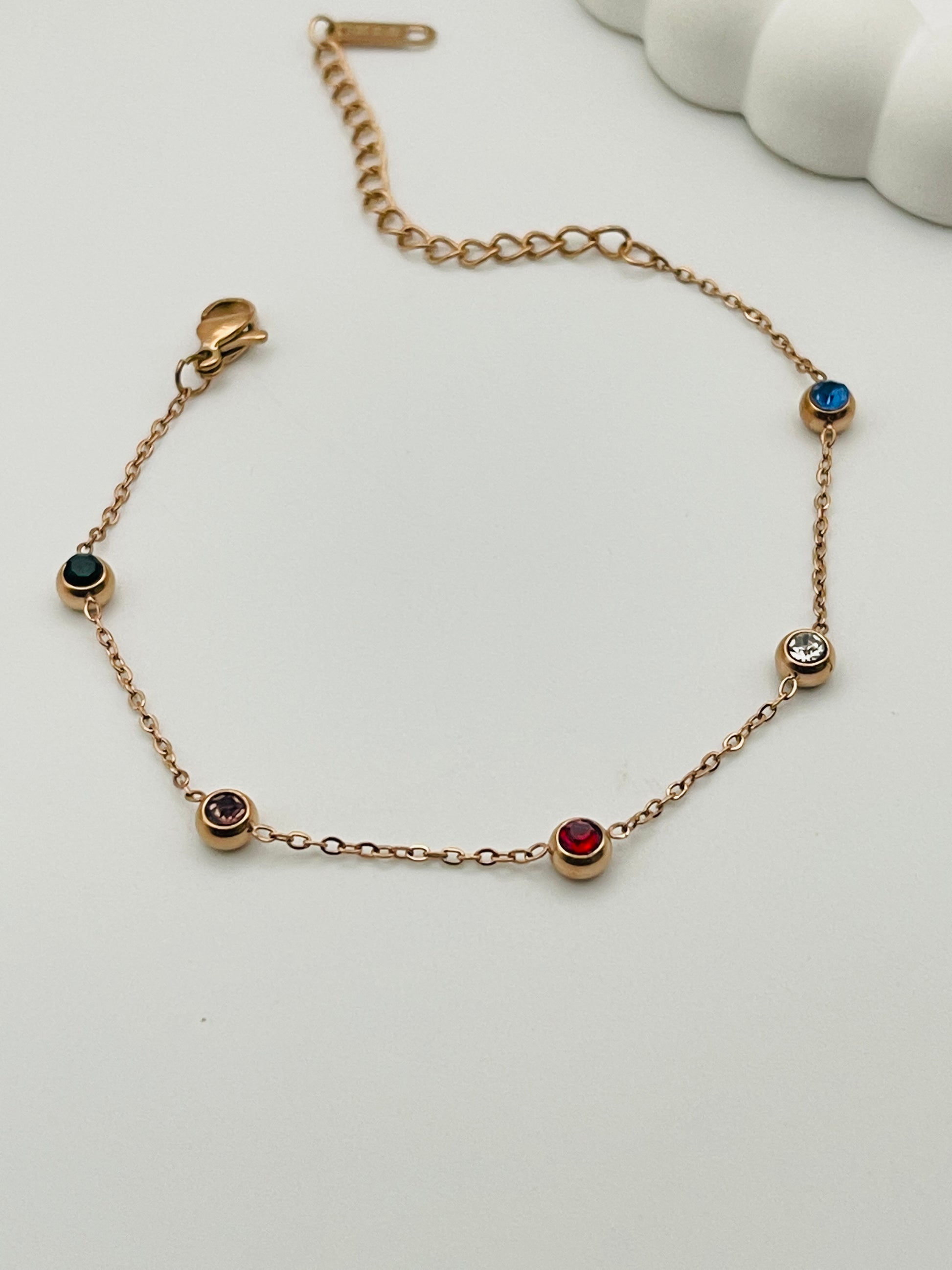 Rose Gold bracelet with gemstones on a white background