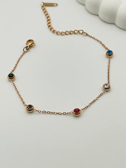 Rose Gold bracelet with gemstones on a white background