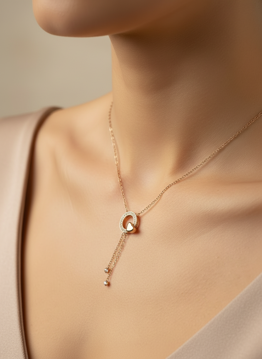 Rose gold necklace on a white mannequin bust with a wooden base.