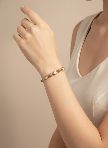 Hand wearing a bracelet with small round beads on a neutral background