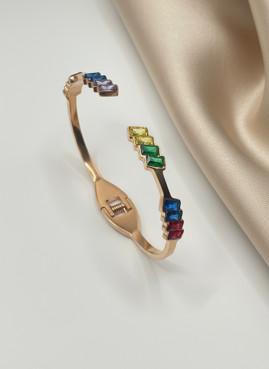 Rose Gold bracelet with colorful gemstones on a beige fabric background