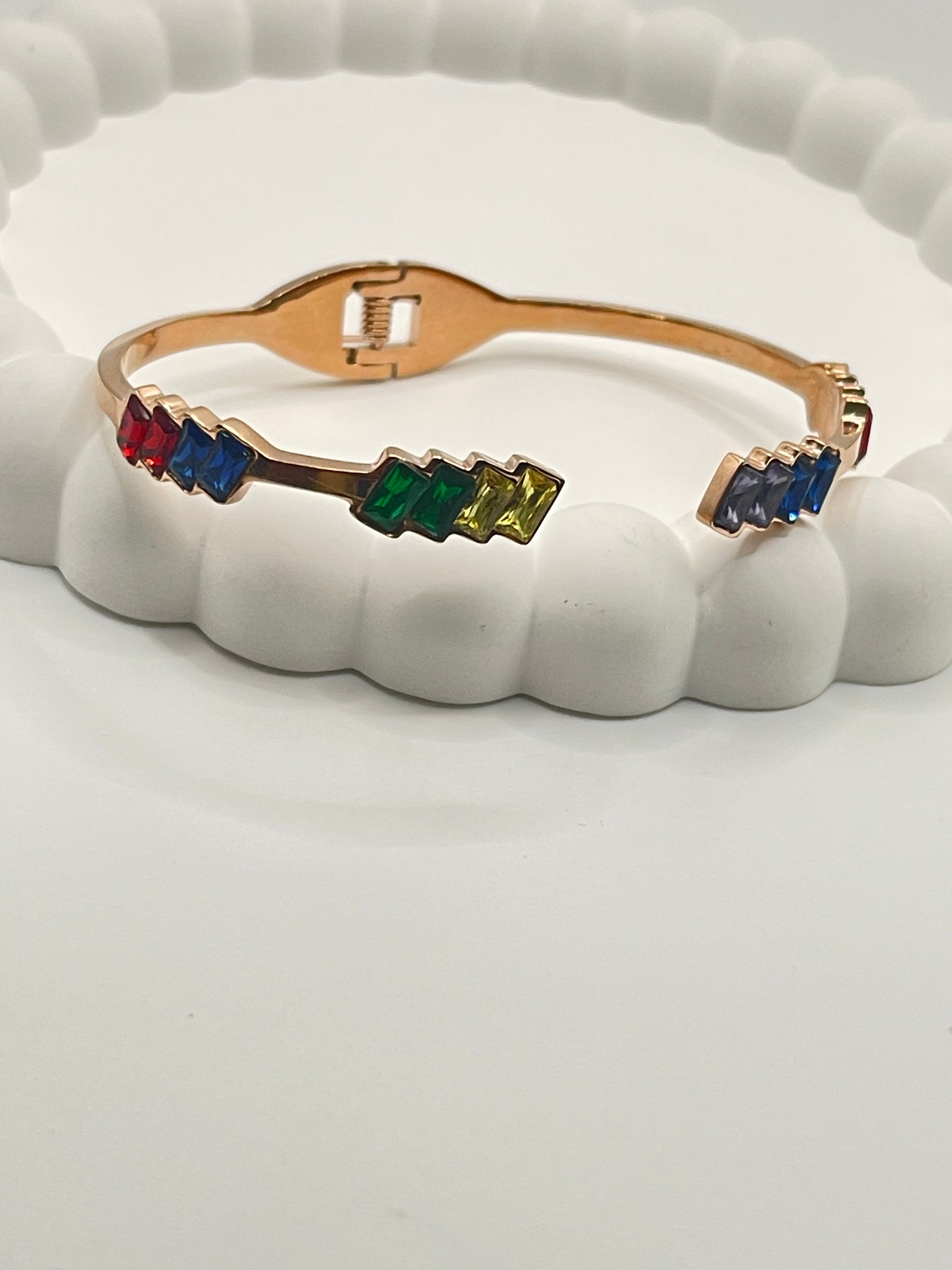 Rose Gold bracelet with colorful gemstones on a white background