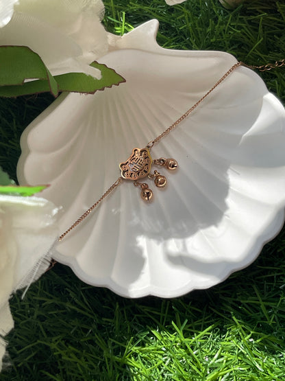 Rose Gold necklace and earrings on a white shell with green grass background