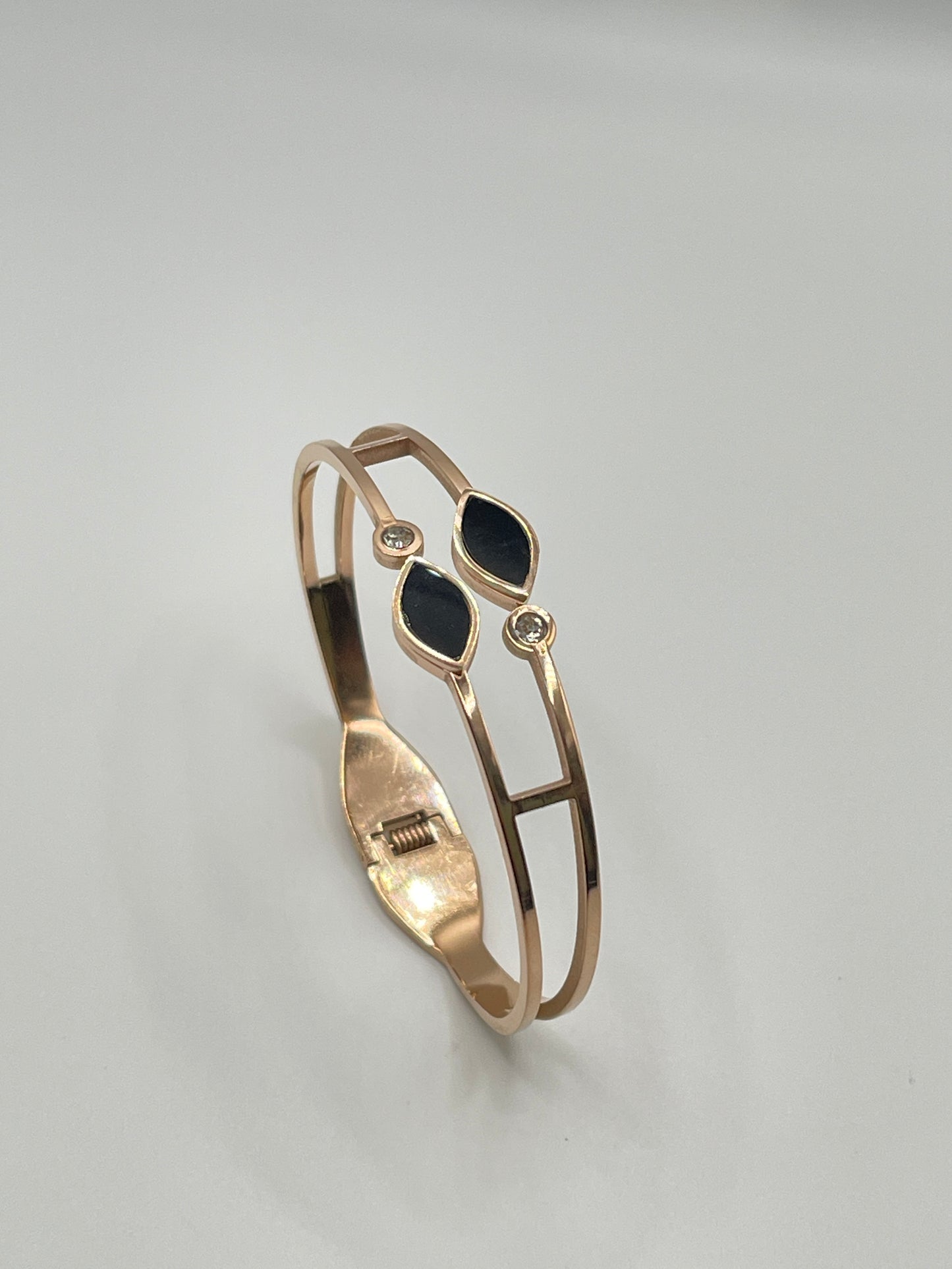 Rose Gold bracelet with black stones on a gray background