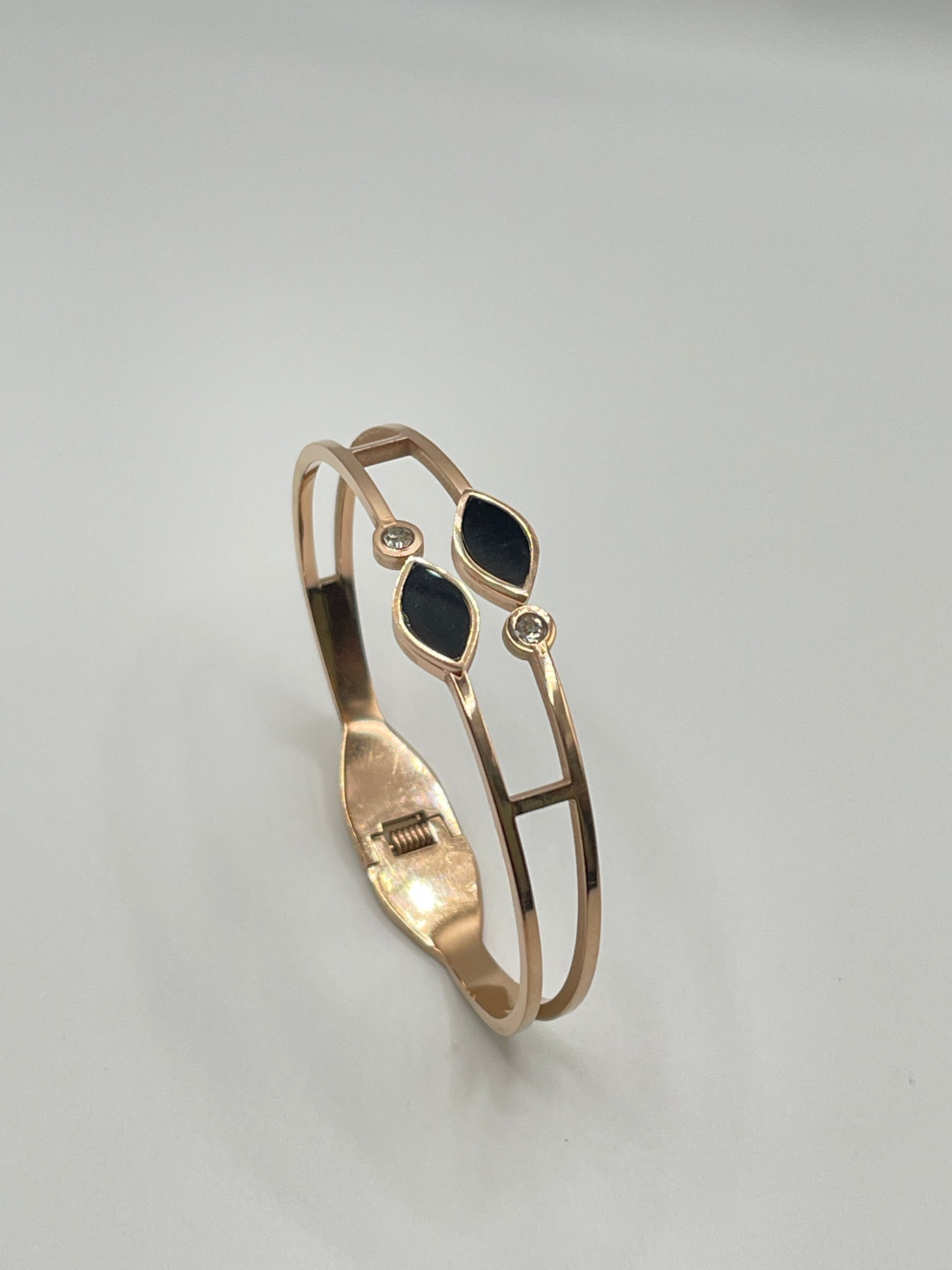 Rose Gold bracelet with black stones on a gray background