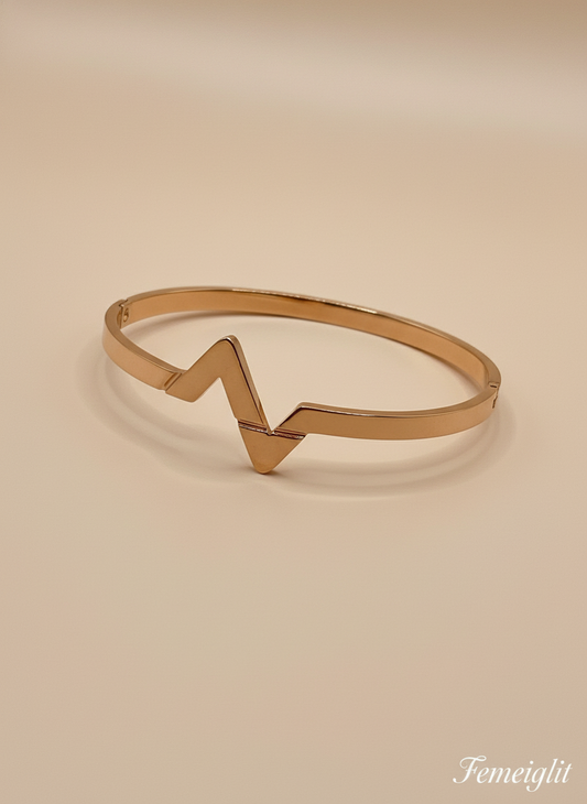 Rose Gold bracelet with a unique design on a beige background