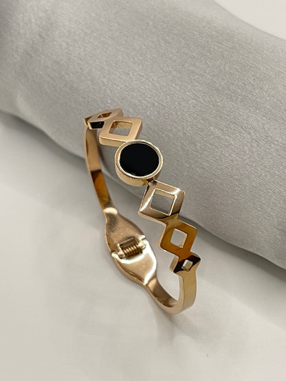 Kids rose Gold bracelet with geometric design on a light gray background