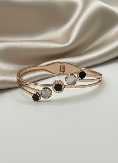 Rose gold bracelet with gemstones on a satin background