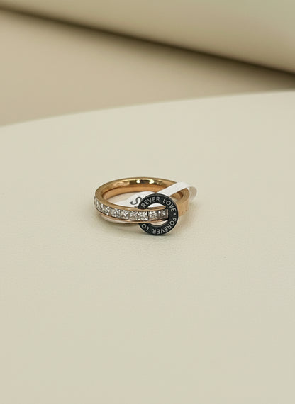 Rose Gold ring with black gemstone on a gray fabric background