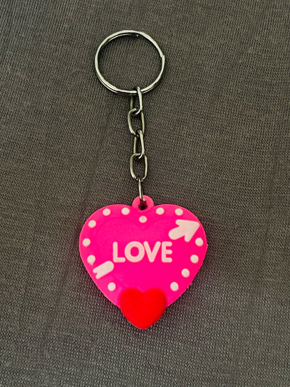 Heart-shaped keychain with 'LOVE' text on a gray background