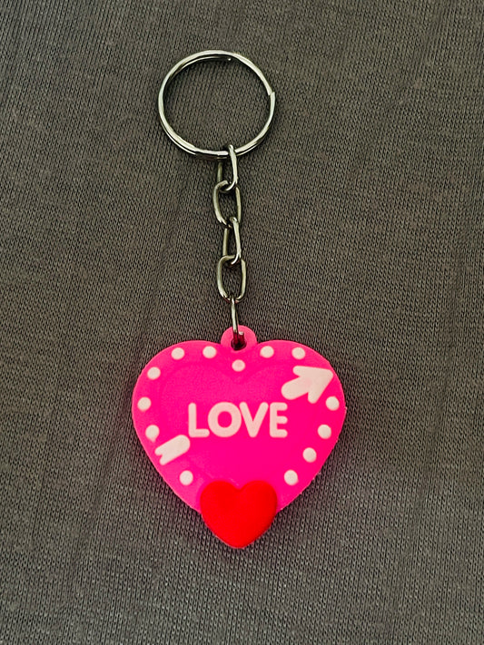 Heart-shaped keychain with 'LOVE' text on a gray background