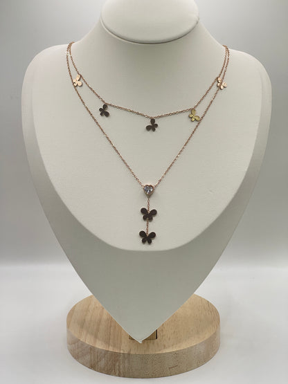 Rose gold Necklace with floral pendants on a white mannequin bust against a gray background