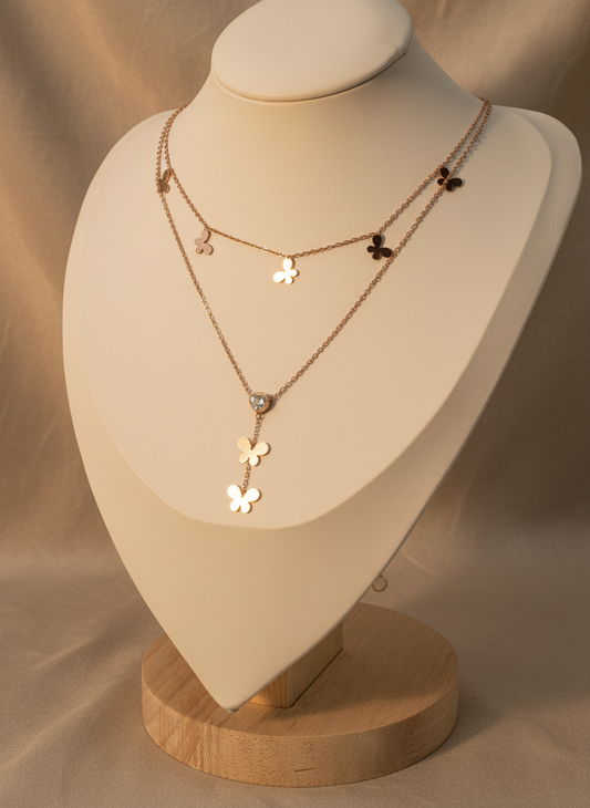 Rose Gold necklace with floral designs on a mannequin bust against a beige background