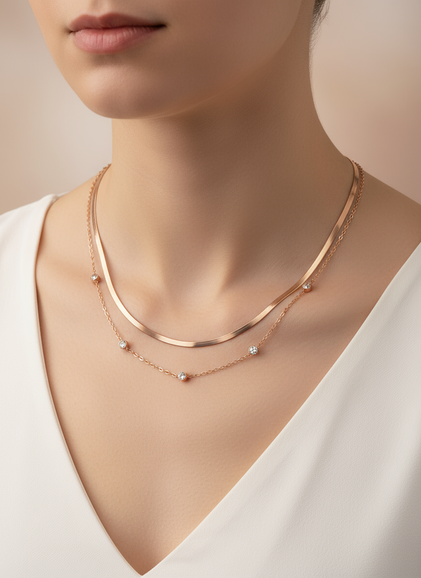 Rose gold necklace on a model wearing a white top