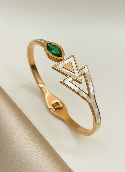 Rose Gold bracelet with green gemstone on a beige background