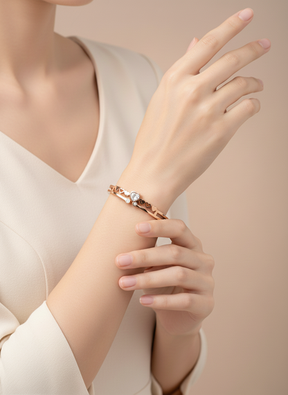 Rose gold bracelet on a person's wrist with a soft beige background